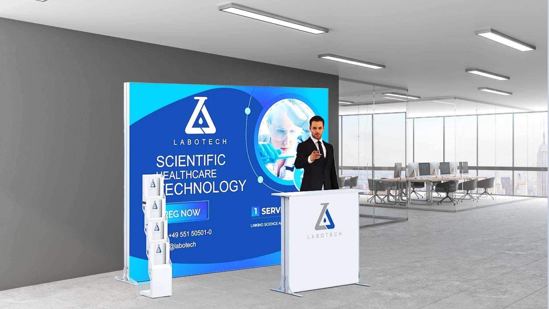 A man in a suit stands at a Labotech podium in a modern office and presents in front of a large screen about scientific health care technology.